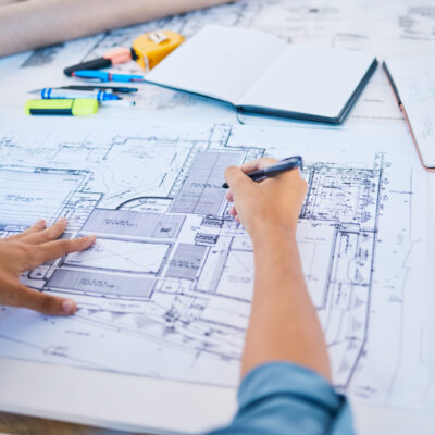 Architect sketching, planning or drawing an architectural design plan or blueprint diagram with dra.