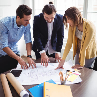 Archtects looking at construction plan in the office