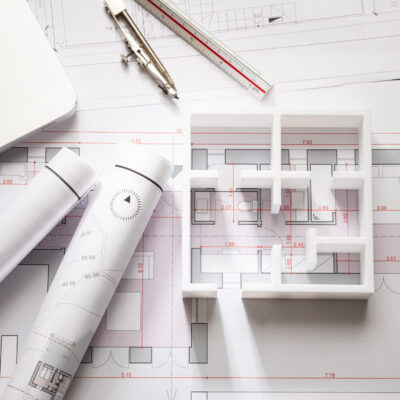 Architect engineer office desk. Blueprint plans and house model, Residential building project architectural design